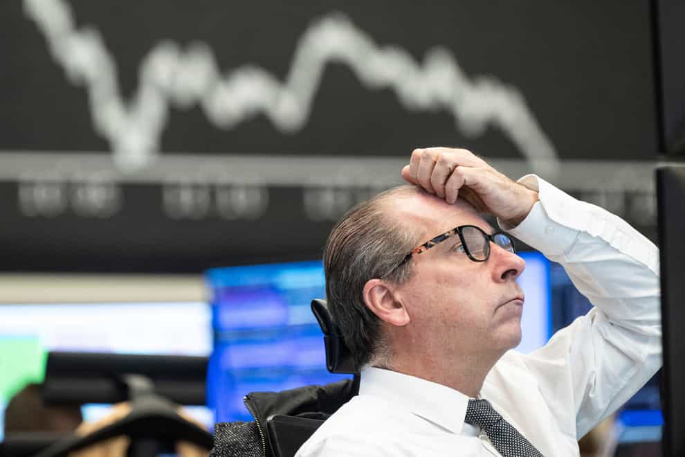 A stock exchange trader observes the price development at the German Stock Exchange in Frankfurt (dpa via AP)
