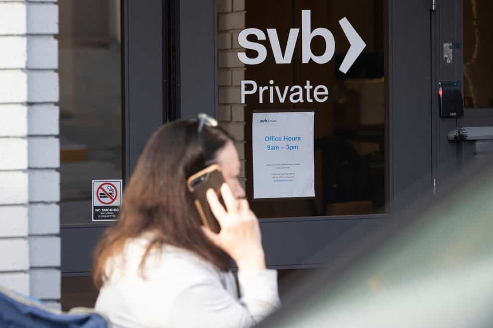 Michele Barry waits outside a Silicon Valley Bank to withdraw funds in Palo Alto, California (Benjamin Fanjoy/AP)