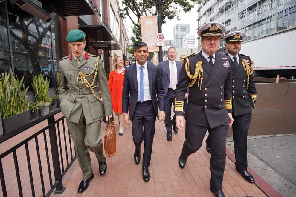 Rishi Sunak (centre) with (l to r) Col Jaimie Norman, Admiral Sir Ben Key, First Sea Lord, and Commander Gus Carnie during his visit to San Diego (Stefan Rousseau/PA)
