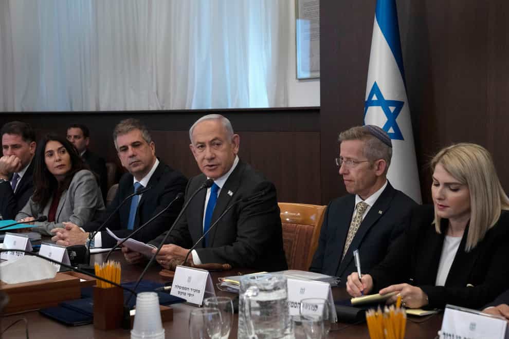 Israel’s Prime Minister Benjamin Netanyahu, center, makes opening remarks at the weekly cabinet meeting in Jerusalem (Maya Alleruzzo/AP)