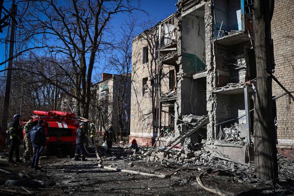 Ukrainian Emergency Service rescuers work in a building damaged by shelling in Kramatorsk (Roman Chop/AP)