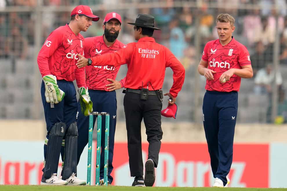 England captain Jos Buttler, left, with team-mates Moeen Ali, second left, and Sam Curran as Bangladesh wrapped up a 3-0 T20 series win (Aijaz Rahi/AP).