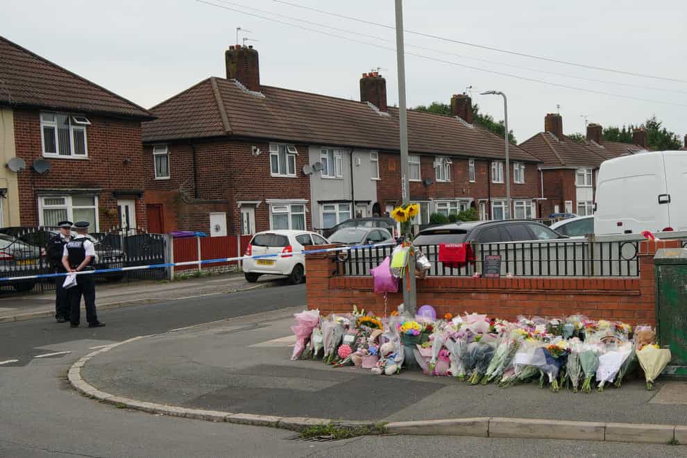 Flowers are left on Kingsheath Avenue after Olivia Pratt-Korbel was killed (Peter Byrne/PA)