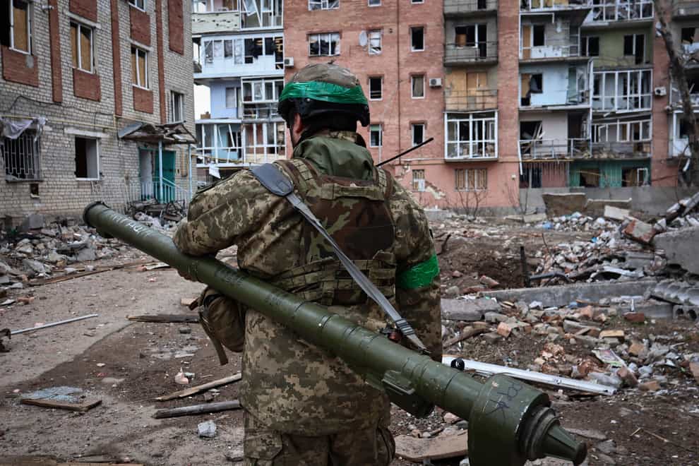 A Ukrainian soldier carries a portable anti-aircraft missile system in Bakhmut, Donetsk region, Ukraine (Roman Chop/AP)