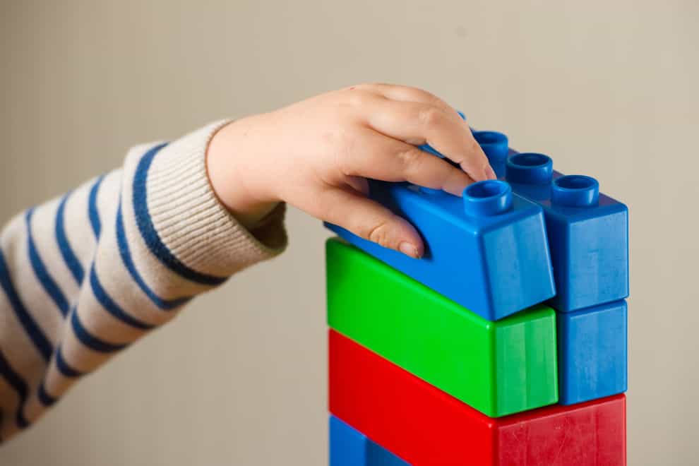 File photo dated 24/01/16 of a preschool age child playing with plastic building blocks. Nearly half of children are not developmentally ready for Reception, teachers have reported in a report from early years charity Kindred2.