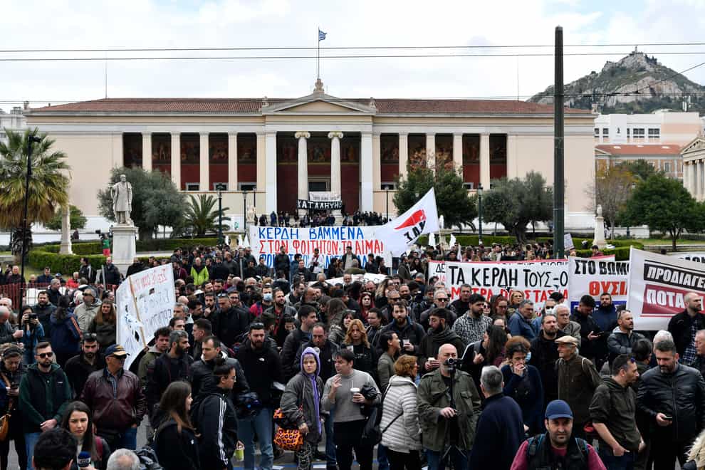 Protestors hold banners during a 24-hours general strike in central Athens, on Thursday, March 16, 2023. Strikes by labor unions in Greece following a rail disaster last month have disrupted public transport and extensively disrupted services, with protests in cities across Greece planned later Thursday. (AP Photo/Michael Varaklas)