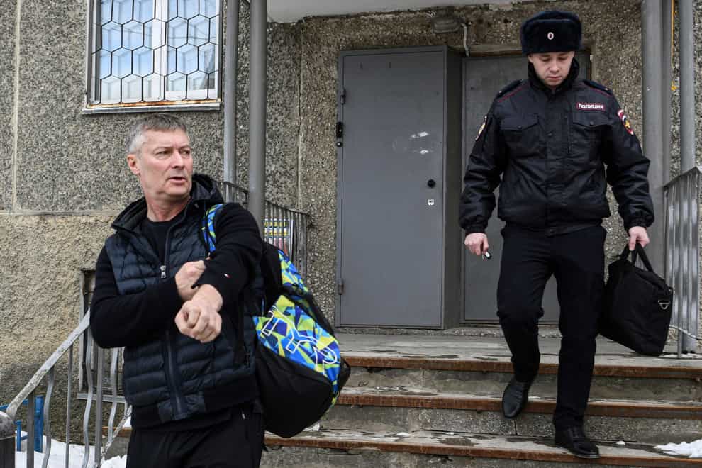 Yevgeny Roizman, former mayor of Russia’s fourth-largest city, walks escorted by a police officer in Yekaterinburg, Russia, Thursday, March 16, 2023. Roizman has been detained on charges that could land him behind bars as part of authorities’ efforts to muzzle dissent. Yevgeny Roizman is a sharp critic of the Kremlin and one of the most visible and charismatic opposition figures in Russia. (AP Photo/Vladimir Podoksyonov)