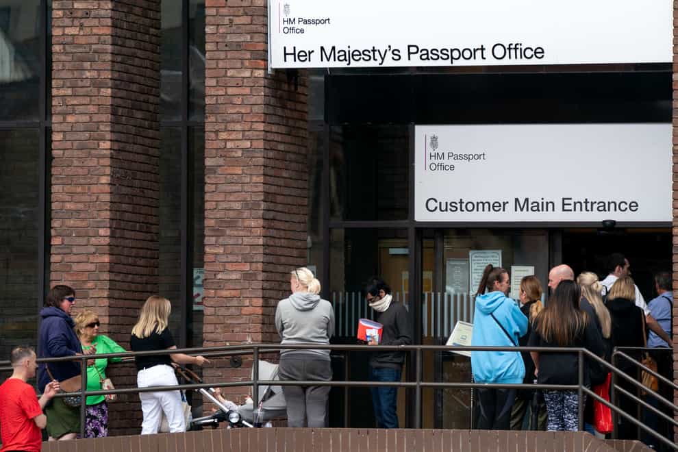 People queue outside the passport office in Peterborough (Joe Giddens/PA)