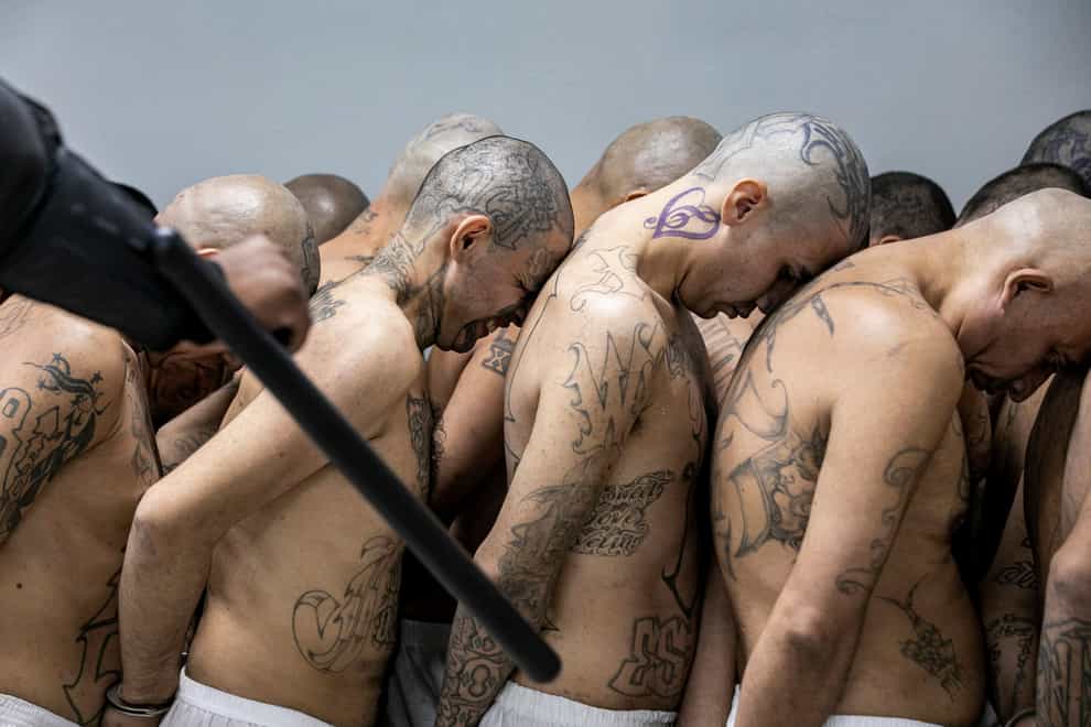 Inmates identified by authorities as gang members are moved at the Terrorism Confinement Centre in Tecoluca, El Salvador (El Salvador presidential press office/AP)