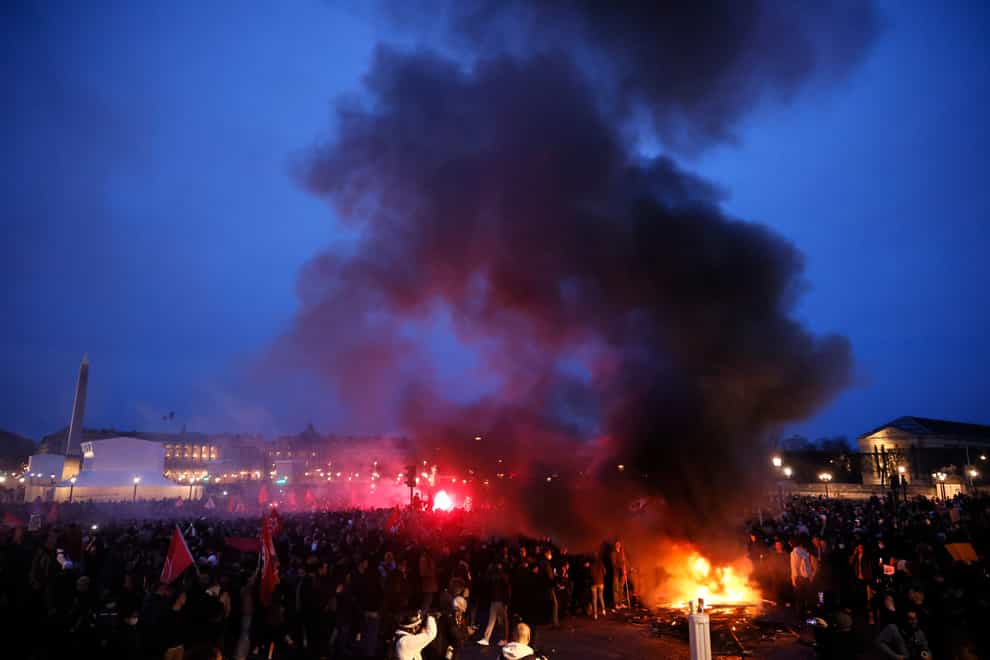 Pallets burn as protesters demonstrate at Concorde square near the National Assembly in Paris (Thomas Padilla/AP)