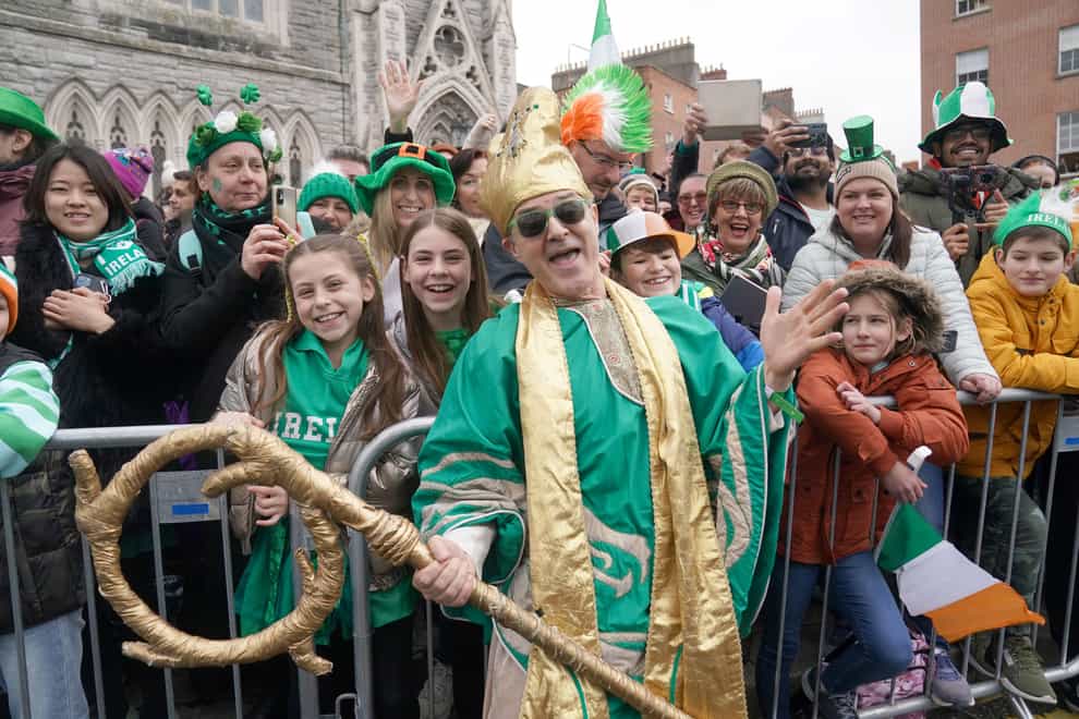 A performer poses with spectators at the St Patrick’s Day parade in Dublin (PA/Brian Lawless)