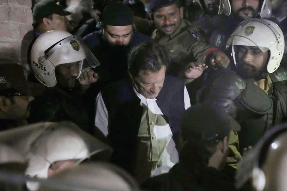 Police make way for Imran Khan as he arrives to appear at court in Lahore (K.M. Chaudhry/AP)