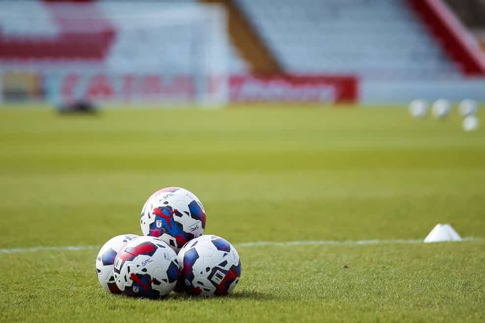 Footballs are placed on the pitch prior to warm up during the Sky Bet League Two match at the Lamex Stadium, Stevenage. Picture date: Saturday March 11, 2023.