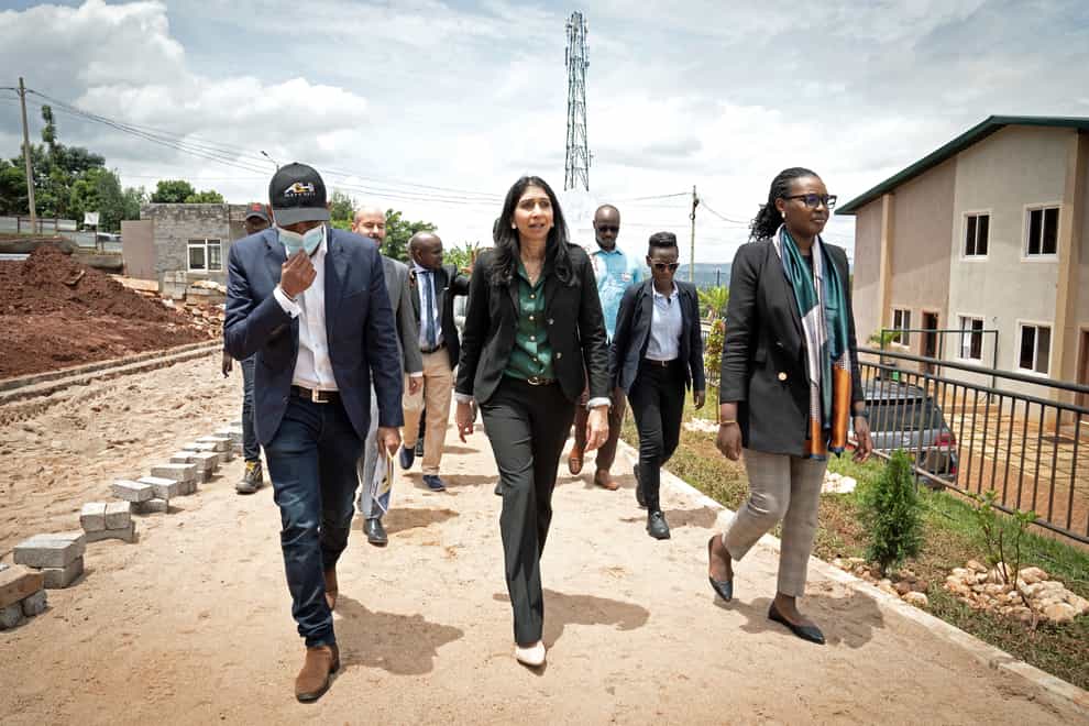 Home Secretary Suella Braverman, centre, tours a building site on the outskirts of Kigali during her visit to Rwanda (Stefan Rousseau/PA)