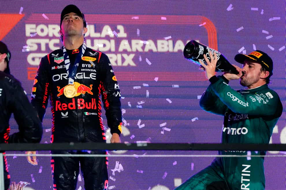 Fernando Alonso, right, had celebrated on the podium (Hassan Ammar/AP)