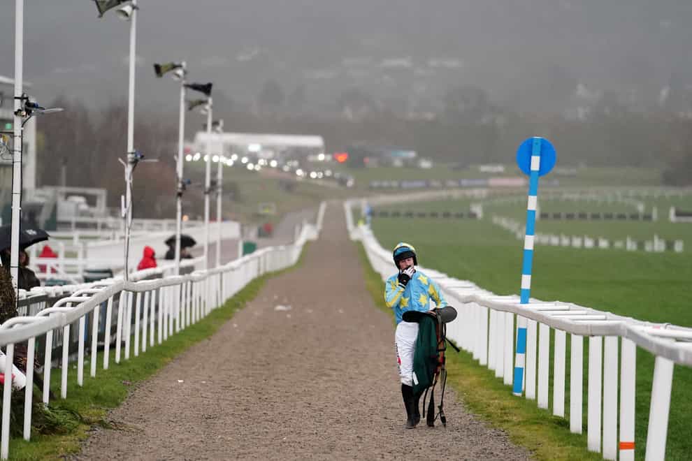 Jockey J C Barry walks back after falling from Mahler Mission in the WellChild National Hunt Challenge Cup Amateur Jockeys’ Novices’ Chase on day one of the Cheltenham Festival at Cheltenham Racecourse (David Davies/PA)