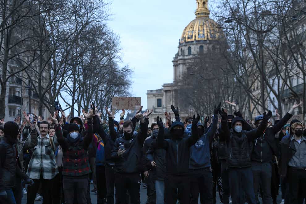 Protesters chant slogans during a protest in Paris, Monday, March 20, 2023. The French government has survived two no-confidence votes in the lower chamber of parliament, proposed by lawmakers who objected to its push to raise the retirement age from 62 to 64. (AP Photo/Lewis Joly)