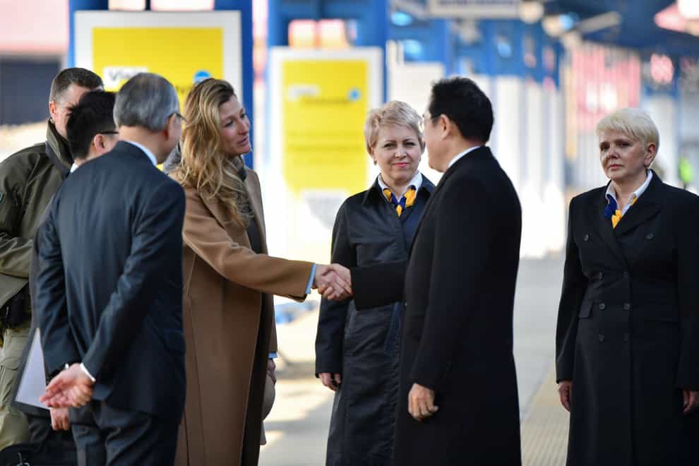 Japanese Prime Minister Fumio Kishida, and Emine Dzhaparova, First Deputy Foreign Minister of Ukraine shake hands at the railway station in Kyiv, Ukraine, Tuesday, March 21, 2023. (Ukrainian Presidential Press Office via AP)