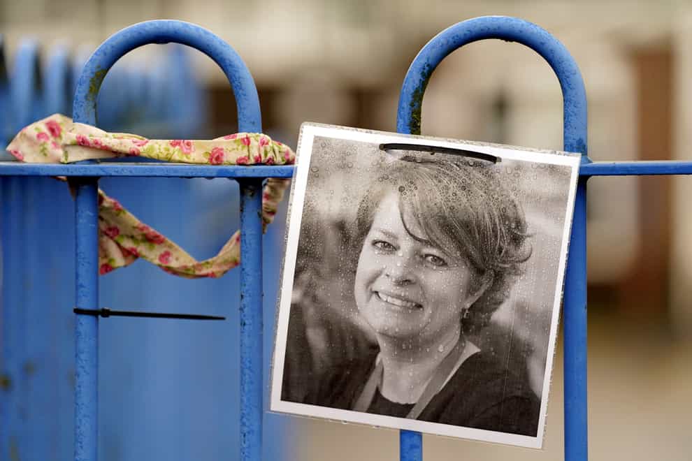 A photograph of Ruth Perry attached to the fence outside John Rankin Schools in Newbury (Andrew Matthews/PA)