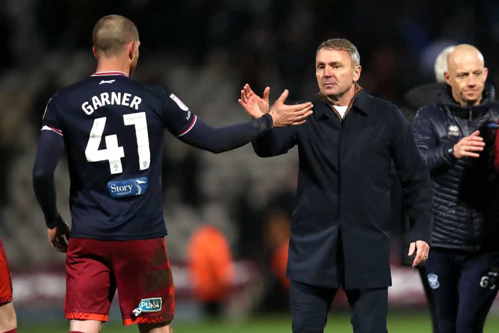 Carlisle United’s Joe Garner (left) and manager Paul Simpson shake hands after the final whistle in the Sky Bet League Two match at the University of Bradford Stadium, Bradford. Picture date: Tuesday March 21, 2023.