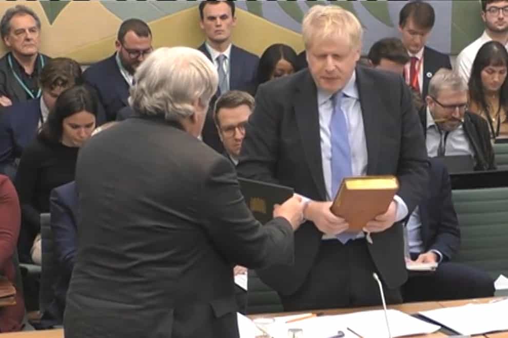 Boris Johnson takes an oath before giving evidence (House of Commons/UK Parliament/PA)