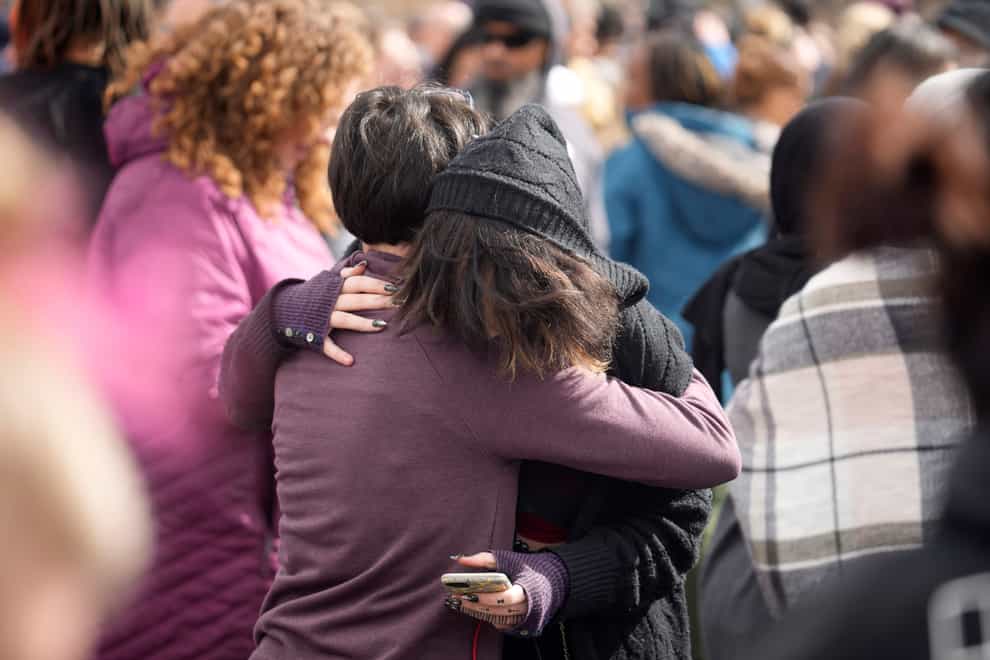 A parent hugs a student as they are reunited after a school shooting in Denver (David Zalubowski/AP)