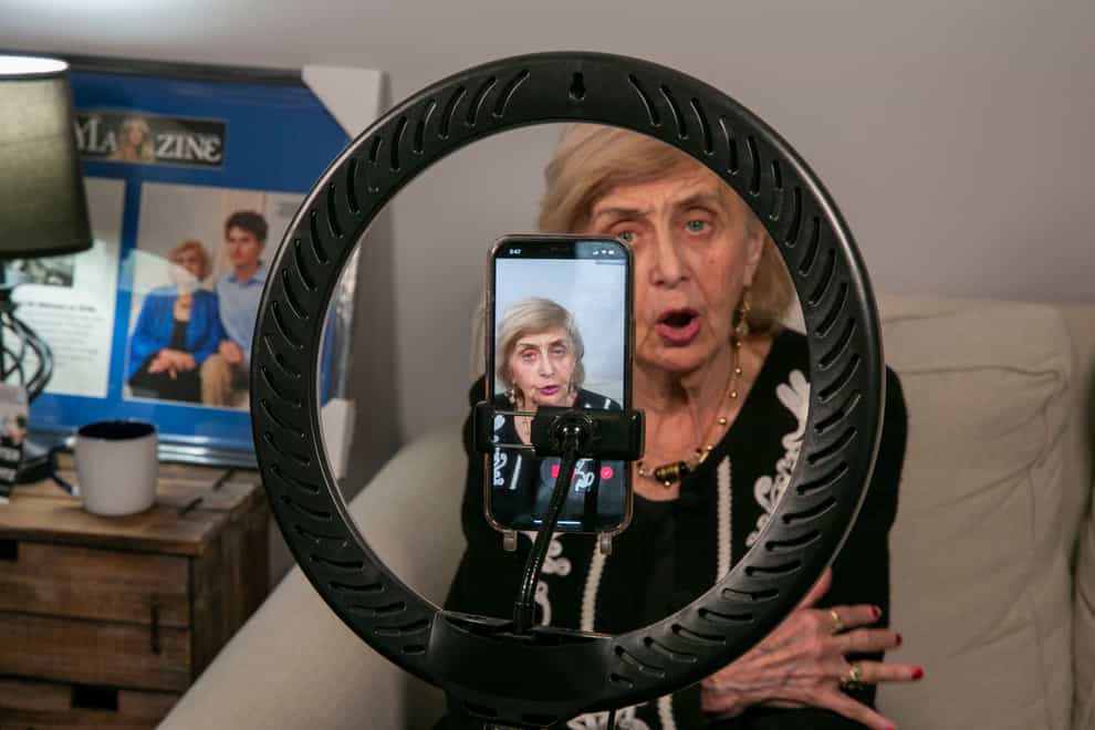 Holocaust survivor Tova Friedman, 85, prepares to record a TikTok video with her grandson, 17-year-old Aron Goodman, in Morristown, New Jersey (Ted Shaffrey/AP)