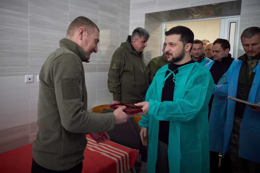 Volodymyr Zelensky awards a soldier in hospital in Donetsk region on Wednesday (Ukrainian Presidential Press Office/AP)