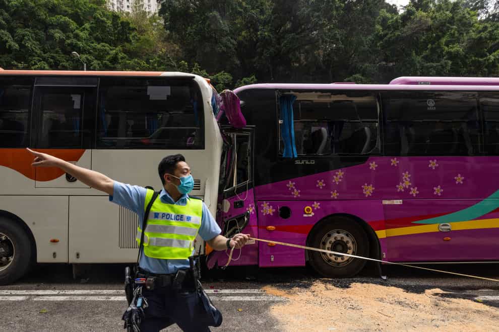 A policeman at the scene of a crash in Hong Kong (Louise Delmotte/AP)