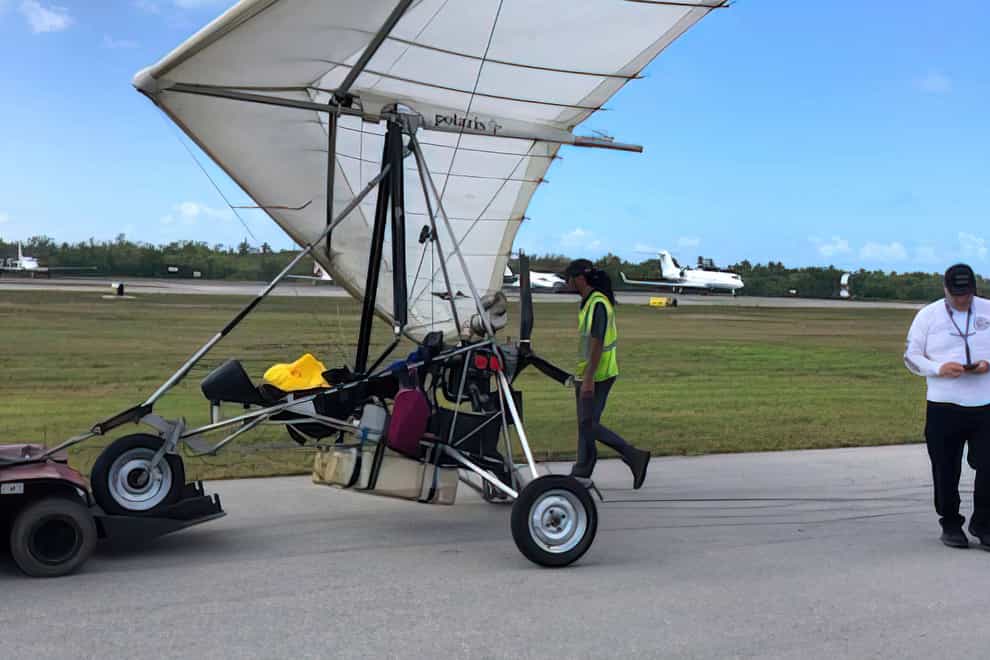 Key West International Airport personnel examine an ultralight aircraft that landed illegally at the airport carrying two Cuban men (Monroe County Sheriff’s Office/The Florida Keys News Bureau/AP)