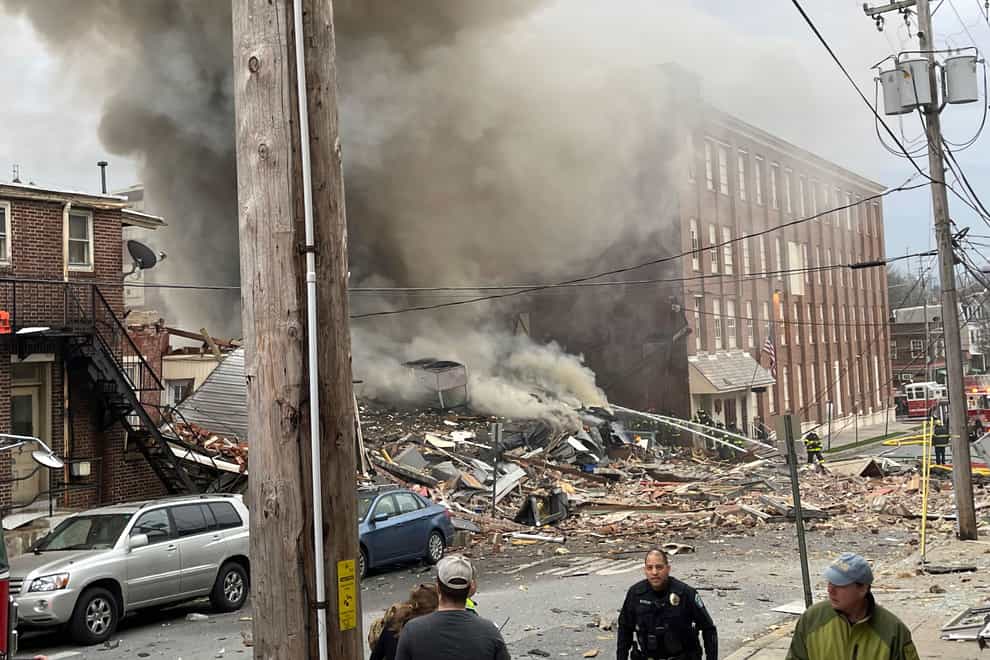 Rescuers are continuing the search for four people missing after an explosion at a chocolate factory in Pennsylvania which killed three people (Ben Hasty /Reading Eagle/AP)