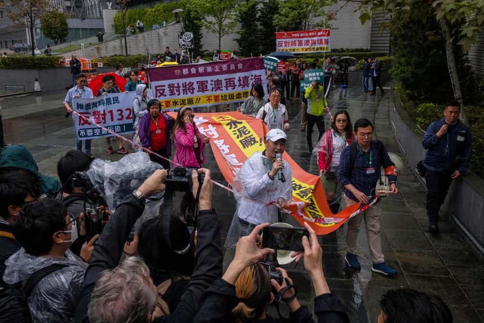 Dozens of people have joined Hong Kong’s first authorised demonstration against the government since the lifting of major Covid-19 restrictions under unprecedentedly strict rules (Louise Delmotte/AP)