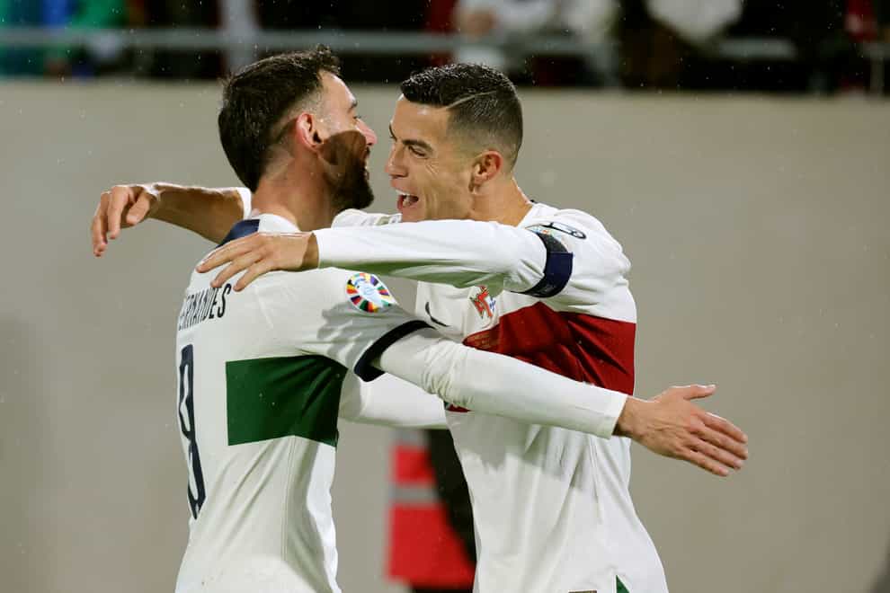 Portugal’s Cristiano Ronaldo (right) celebrates after scoring his side’s fourth goal in their Euro 2024 qualifier against Luxembourg (Olivier Matthys/AP)