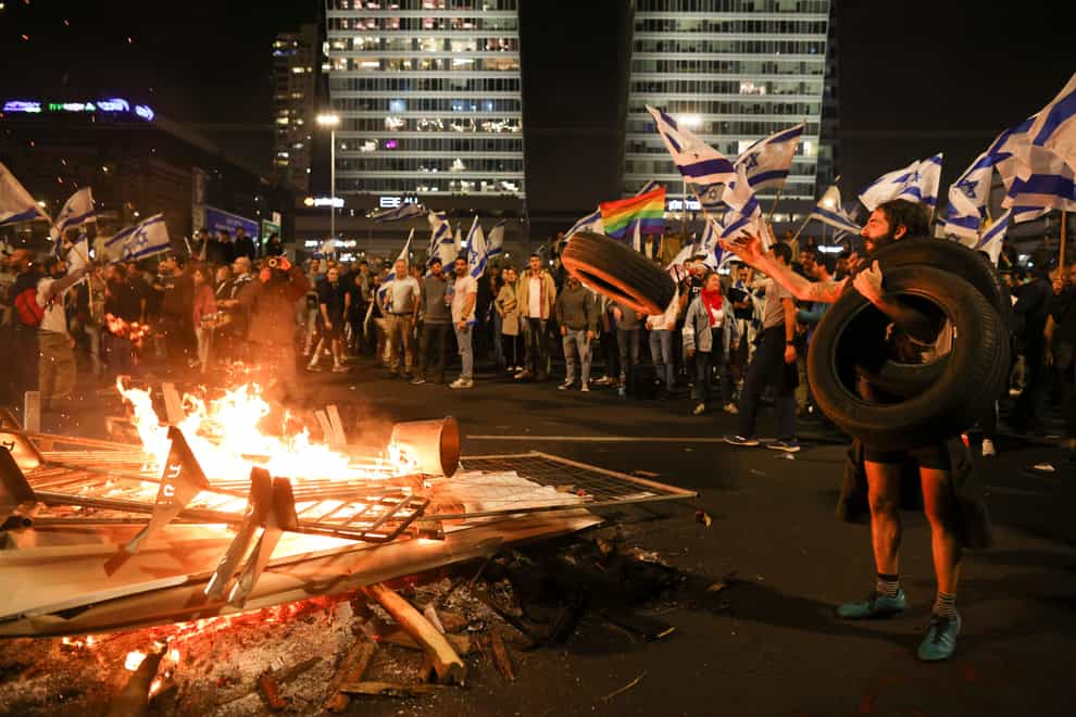 Israelis opposed to Prime Minister Benjamin Netanyahu’s judicial overhaul set up bonfires and block a highway (Oren Ziv/AP)