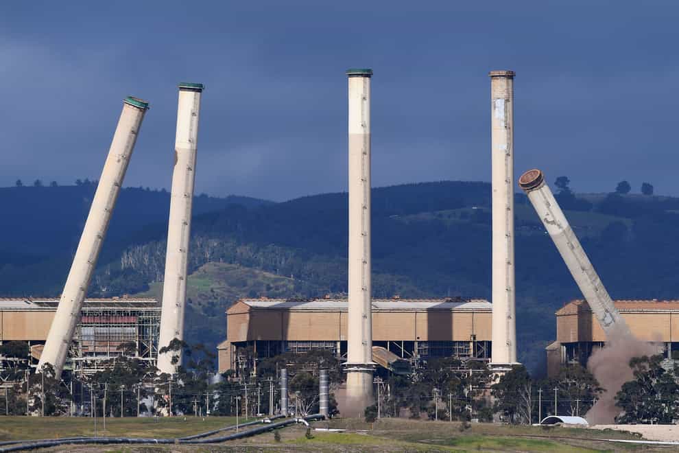 Some of the coal-burning Hazelwood Power Station’s eight chimneys begin to topple as they are demolished and the station is decommissioned in Hazelwood, Victoria (AAP via AP)