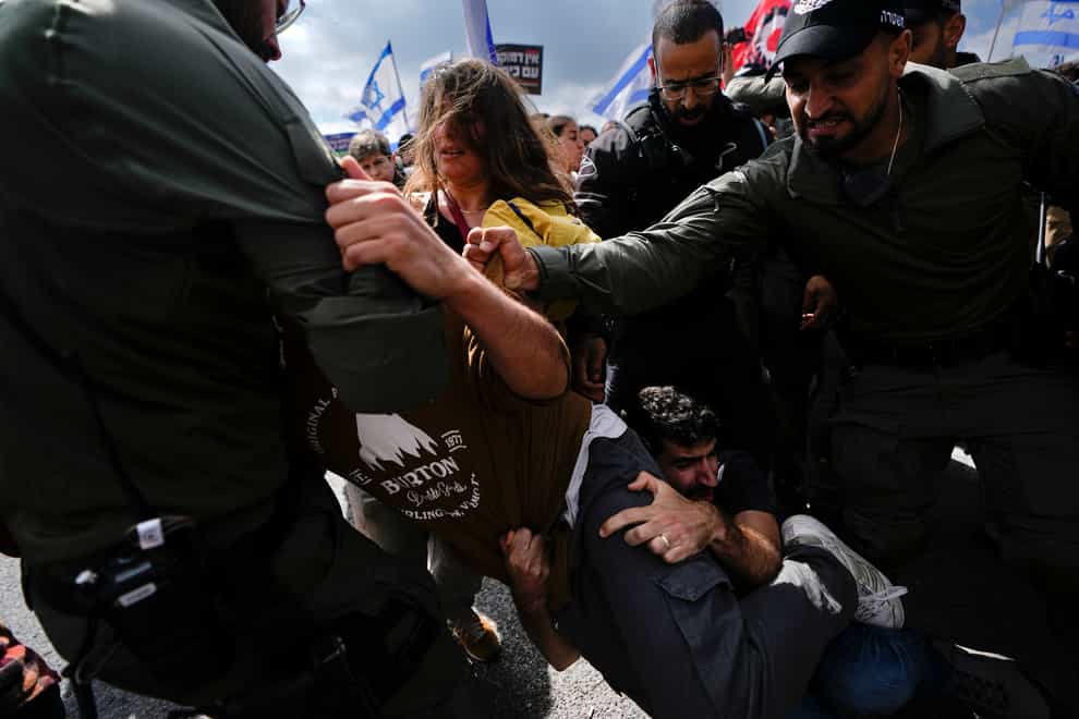 Israelis scuffles with police during a protest against Prime Minister Benjamin Netanyahu’s judicial overhaul plan (AP)