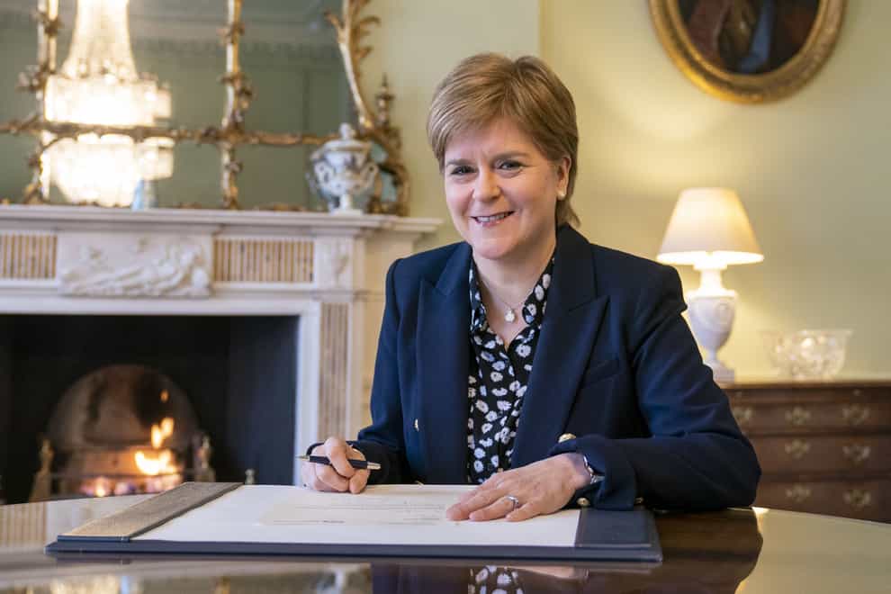 Outgoing First Minster of Scotland Nicola Sturgeon signs her official resignation letter to the King (Jane Barlow/PA)
