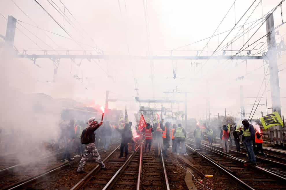 Railway workers demonstrate on the tracks at the Gare de Lyon train station (Thomas Padilla/AP)