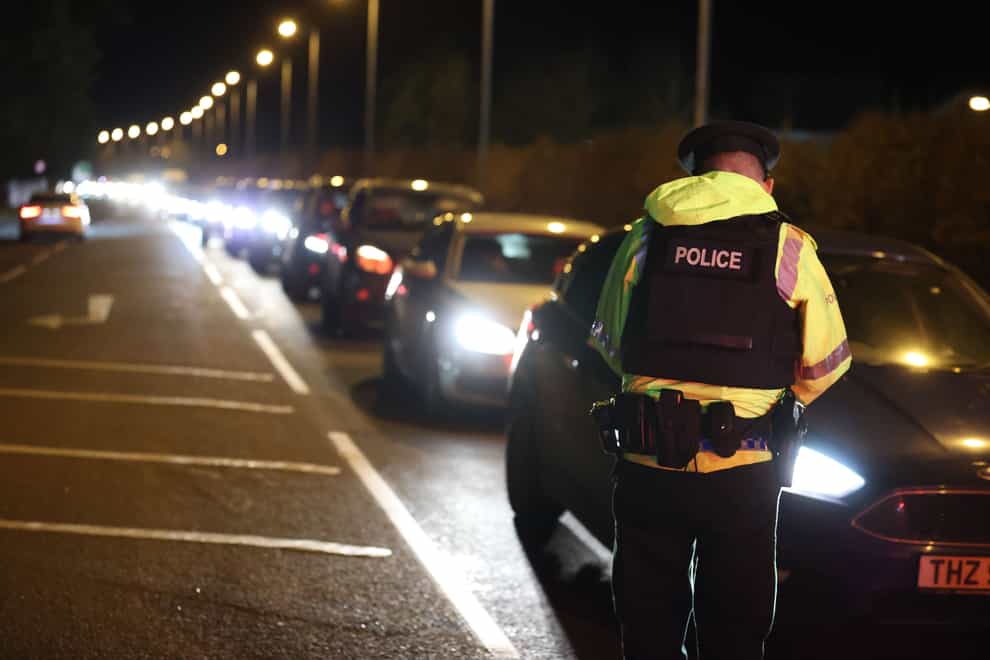 Police officers taking motorists’ details near the sports complex in the Killyclogher Road area of Omagh, Co Tyrone, one week on from where off-duty PSNI Detective Chief Inspector John Caldwell was shot a number of times by masked men (Liam McBurney/PA)