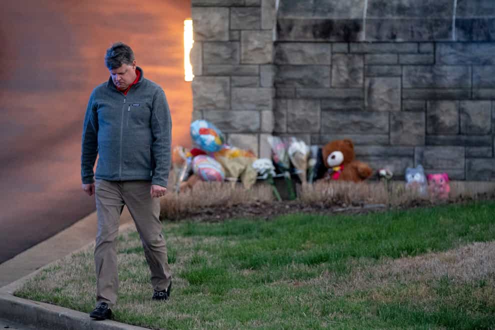 Curtis McDowell, who lives near Covenant School, walks away after placing flowers outside of the school’s entrance in Nashville (Andrew Nelles/The Tennessean via AP)