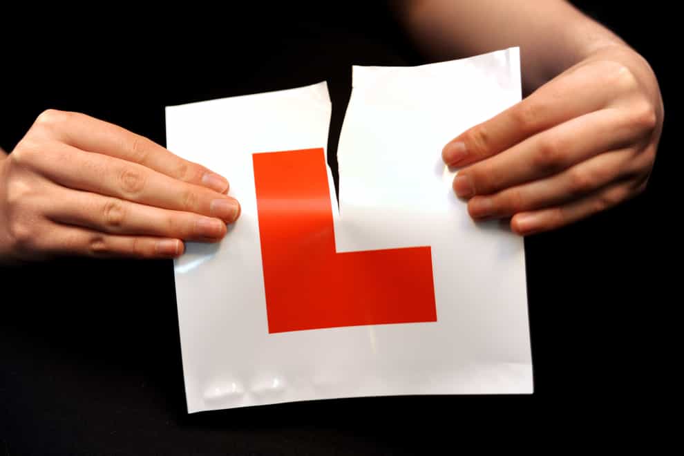 A learner driver rips up her L plate (PA)