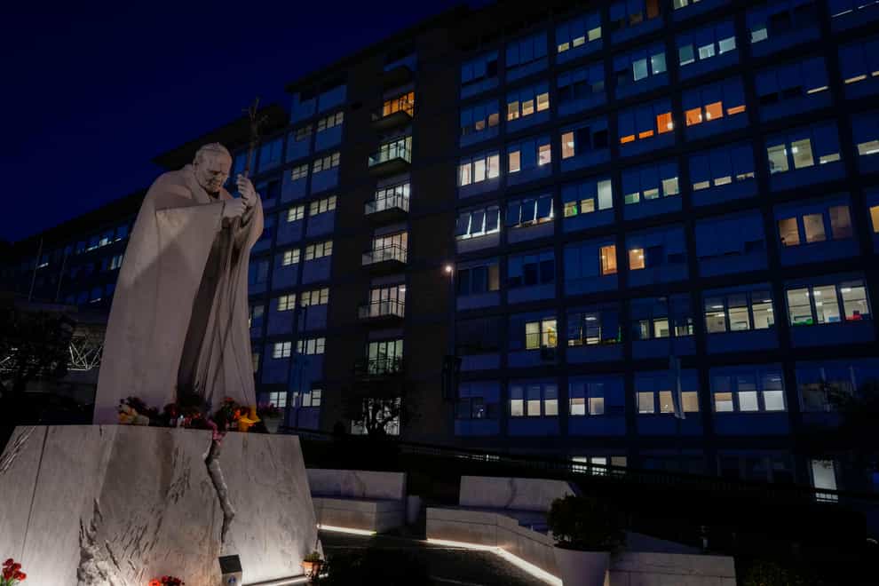 A statue of late Pope St John Paul II stands in front of Gemelli hospital in Rome where Pope Francis is being treated (AP Photo/Andrew Medichini)