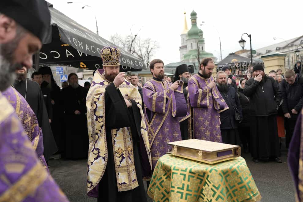 Priests of the Ukrainian Orthodox Church pray with their supporters after resisting a government order to leave the Kyiv Pechersk Lavra monastery (AP)