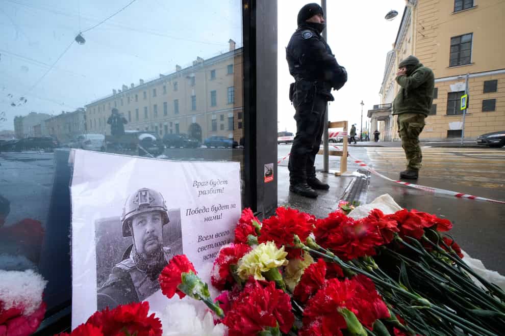 Flowers and a poster with a photo of blogger Vladlen Tatarsky (Dmitri Lovetsky/AP)