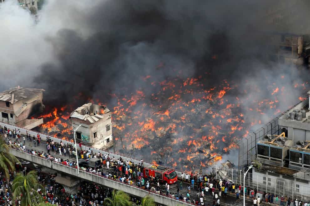 A fire rages at a popular market in Bangladesh’s capital Dhaka (Mahmud Hossain Opu/AP)