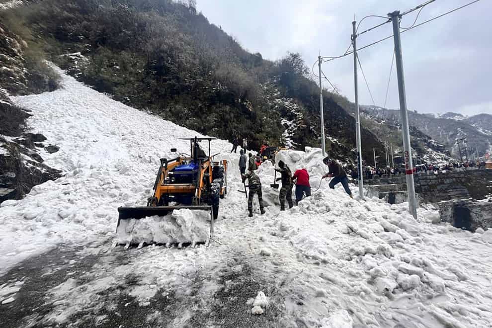 Indian Army soldiers clear snow after an avalanche at Nathu La mountain pass (Indian Army via AP)