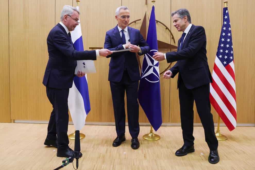 Finnish foreign minister Pekka Haavisto, left, hands over his nation’s accession document to US secretary of state Antony Blinken, right, during a meeting of foreign ministers at Nato headquarters (Johanna Geron, Pool Photo via AP)
