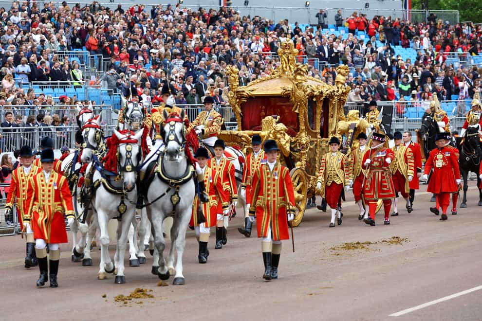 The Gold State Coach passes in front of Buckingham Palace during the Platinum Jubilee Pageant (Hannah McKay/PA)