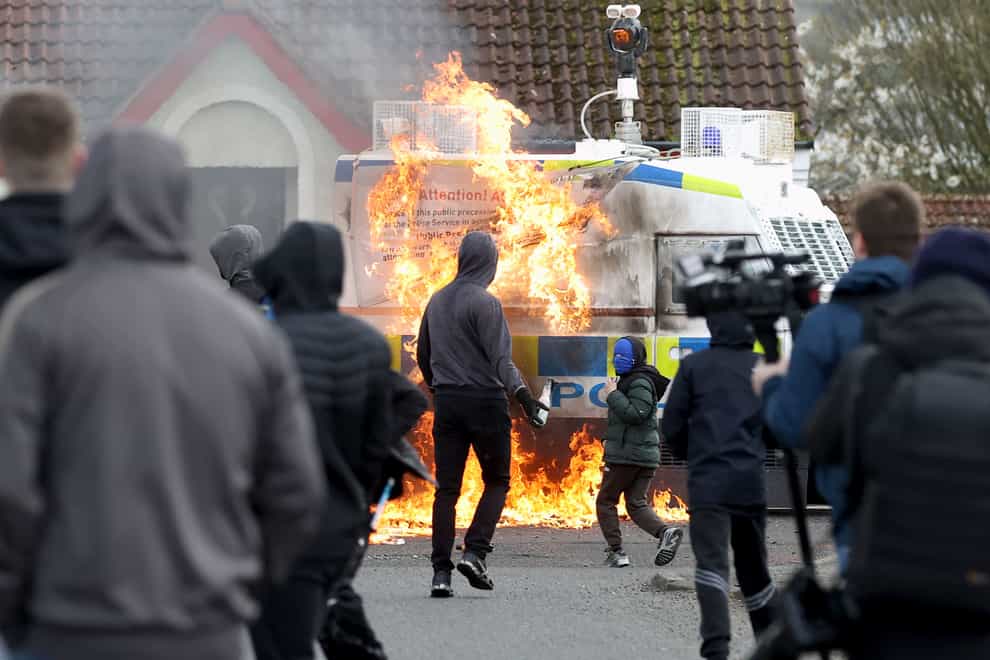 Youths throw petrol bombs at a PSNI vehicle ahead of a dissident Republican parade in the Creggan area of Londonderry on Easter Monday (Liam McBurney/PA)
