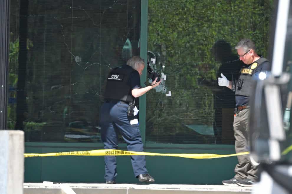 A Louisville bank employee armed with a rifle opened fire at his workplace on Monday morning killing five people while livestreaming the attack on Instagram, authorities said. A Louisville Metro Police technician photographs bullet holes in the front glass of the Old National Bank building in Louisville, April 10, 2023. (Timothy D. Easley, AP Photo)